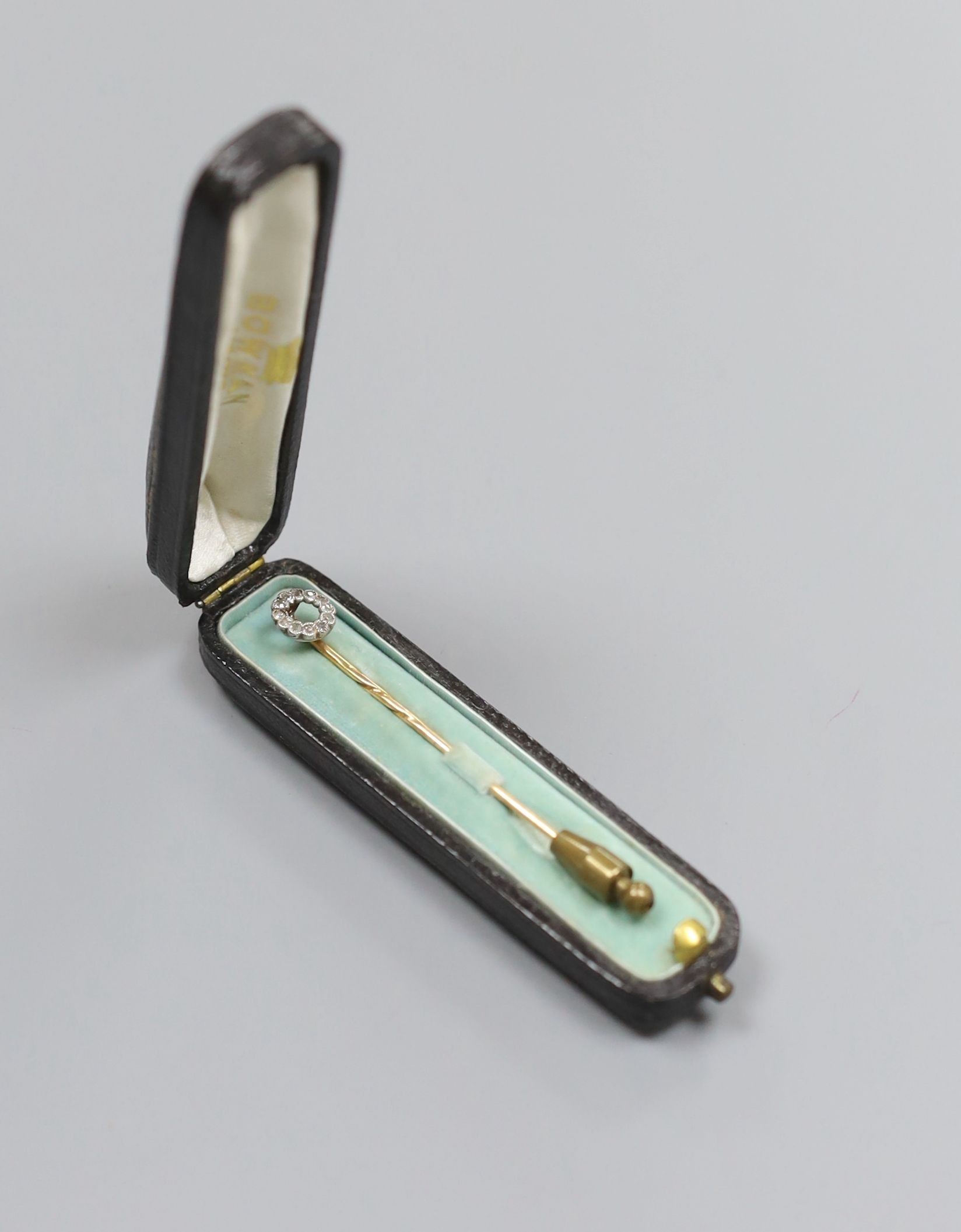 An Edwardian yellow metal and diamond cluster set stick pin, 58mm, gross 1.4 grams.
